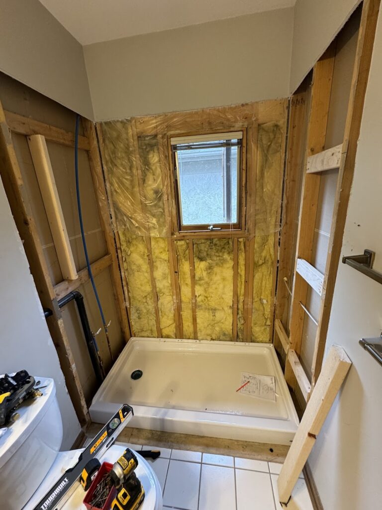 Walk-in shower with matte black hardware and white subway tiles in Columbus, OH.