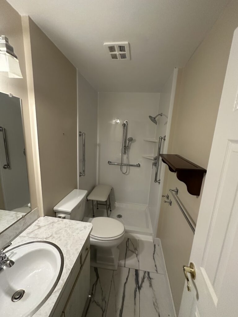 Full tub-to-shower conversion with decorative stone wall panels in Powell, Ohio.