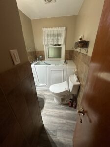 Ceiling-mounted rain shower head installation in a modern walk-in shower in Columbus.
