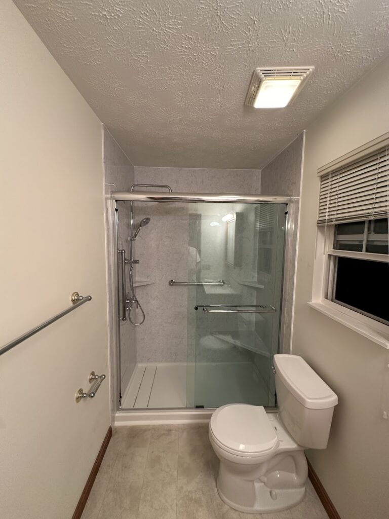 Low-barrier walk-in shower installation with textured tile flooring in Columbus, OH.