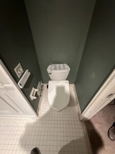 Dark mosaic tile shower floor with light gray wall panels in Powell.