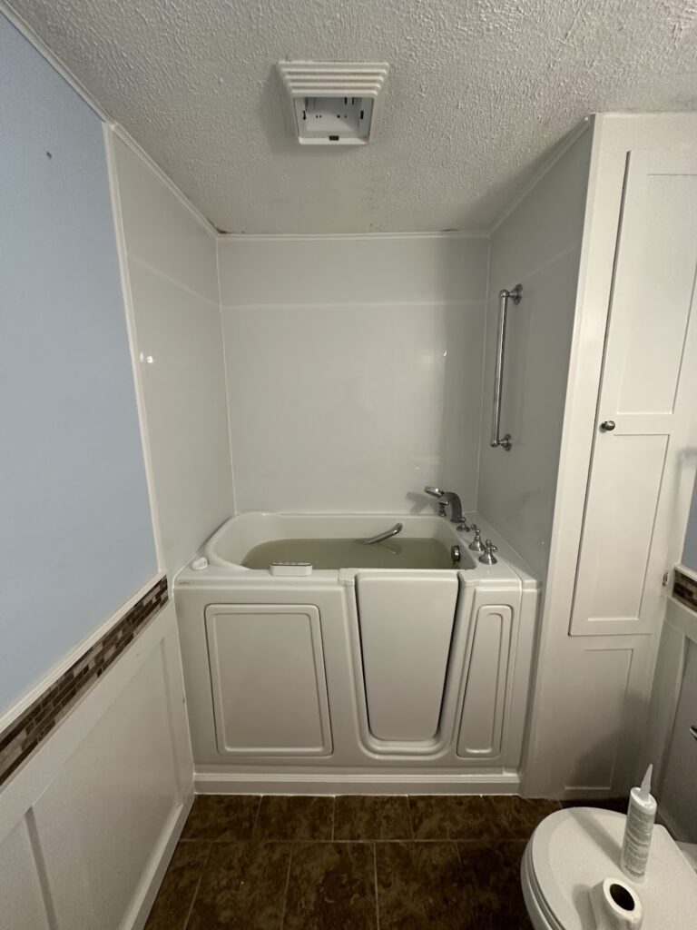 Extendable handheld shower sprayer installed on a walk-in tub in Powell.