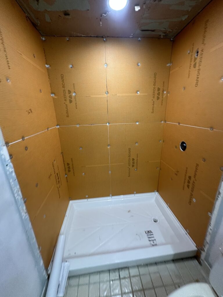 High-gloss white acrylic shower wall panels installation in Columbus, OH.