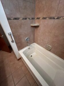 Zero-entry walk-in shower transition with matching floor tiles in Powell.