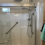 Custom angled stainless steel safety grab bar installed on a bathroom wall in Dublin, OH.