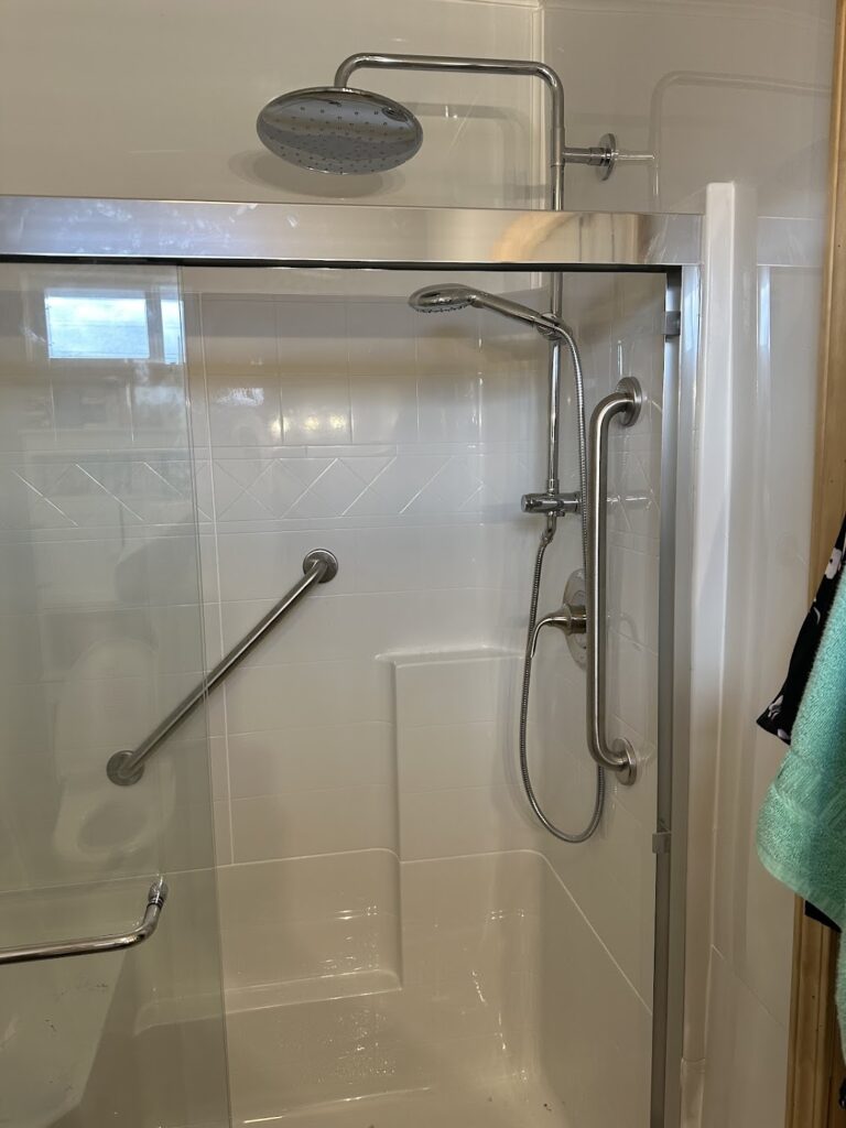 Custom angled stainless steel safety grab bar installed on a bathroom wall in Dublin, OH.