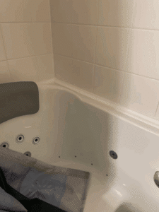 Built-in shower niche with mosaic tile detail and chrome hardware in Dublin, OH.