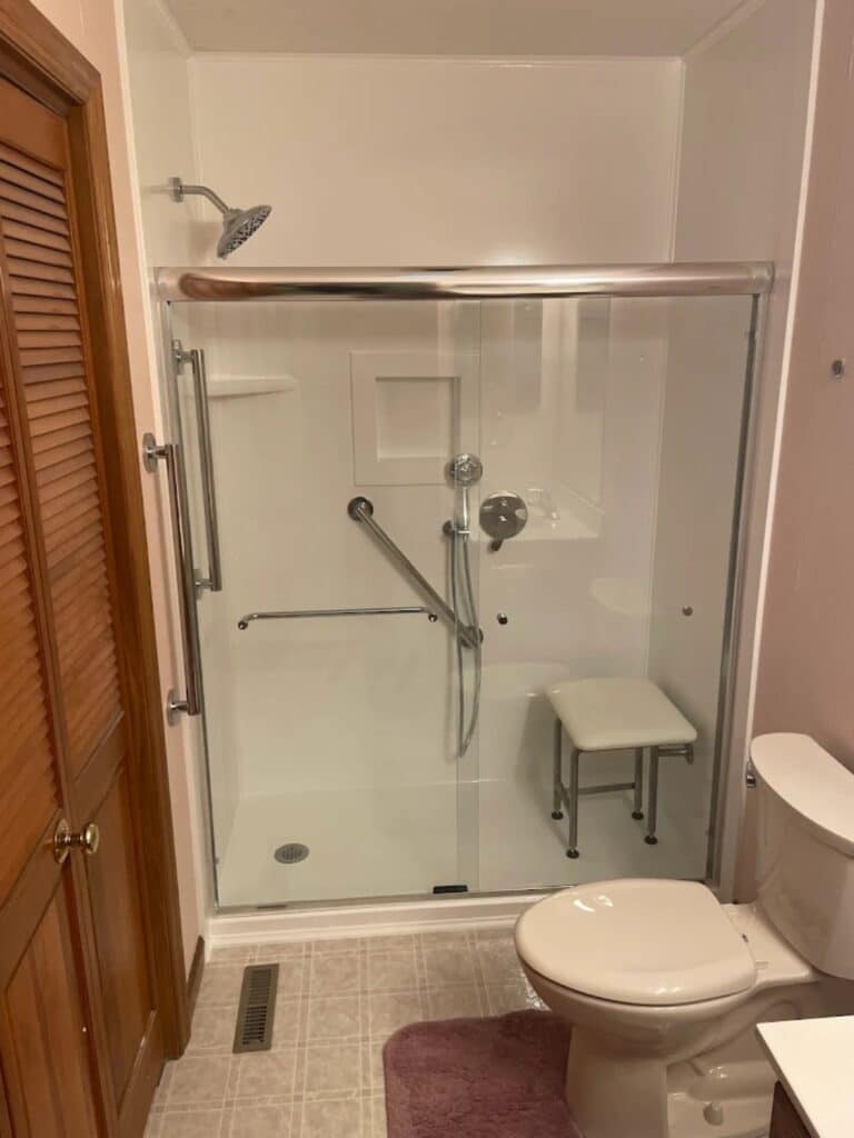 Classic white subway tile shower wall with dark grout and chrome fixtures in Columbus, OH.