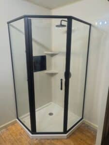 Compact corner walk-in shower featuring a built-in safety bench in Powell, Ohio.
