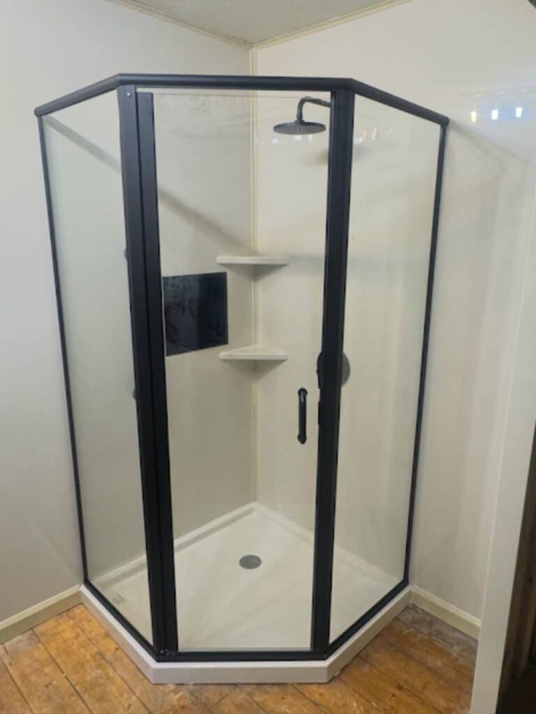 Compact corner walk-in shower featuring a built-in safety bench in Powell, Ohio.