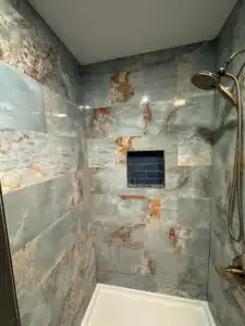 Built-in recessed shower niche with decorative mosaic accent in Dublin, OH.