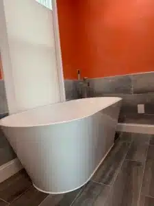 Professional tub-to-shower conversion featuring stone-look wall panels in Dublin, OH.