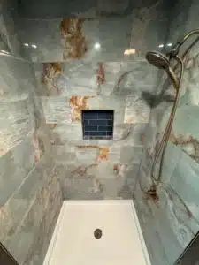 Matte black shower hardware against light gray subway tiles in Columbus, OH.