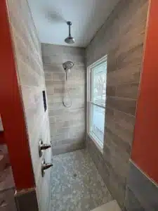 Senior-safe walk-in shower with integrated grab bars and non-slip flooring in Powell.