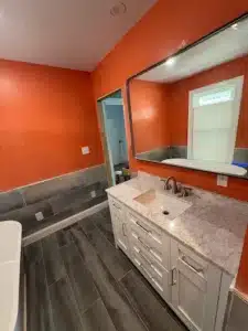 Modern walk-in shower with marble tile walls and frameless glass door in Columbus, OH.