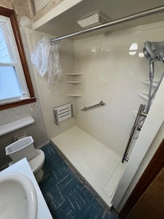 Walk In Shower with Pull down seat, numerous grab bars and beautiful showerhead with wand by American Standard